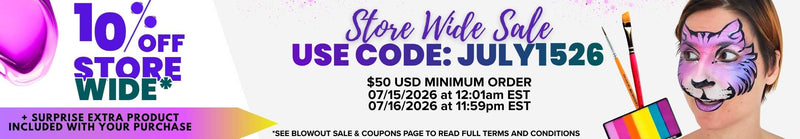 Promotional banner for a face paint store-wide sale. The text reads: "10% OFF STORE WIDE* + SURPRISE EXTRA PRODUCT INCLUDED WITH YOUR PURCHASE. Store Wide Sale USE CODE: JULY1526. $50 USD MINIMUM ORDER 07/15/2026 at 12:01am EST 07/16/2026 at 11:59pm EST. *SEE BLOWOUT SALE & COUPONS PAGE TO READ FULL TERMS AND CONDITIONS." The right side shows a woman with purple tiger face paint, paintbrushes, and a rainbow paint palette.
